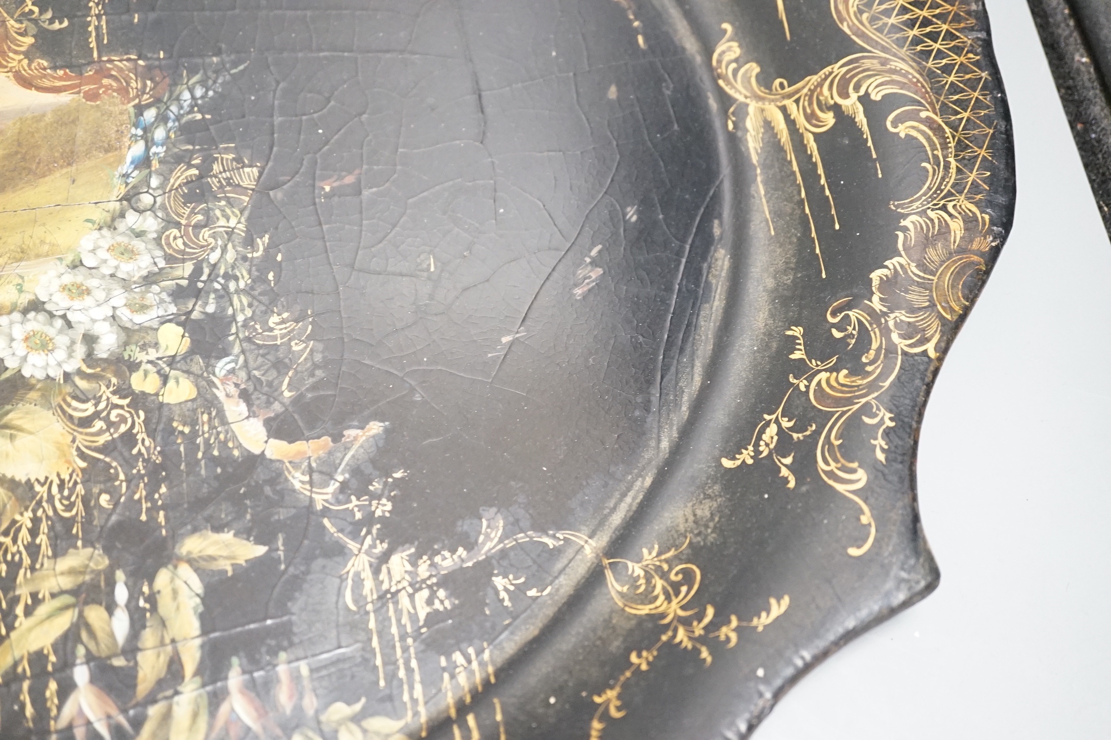 A Victorian papier mache tray, painted with ruins in a landscape - 64cm wide
